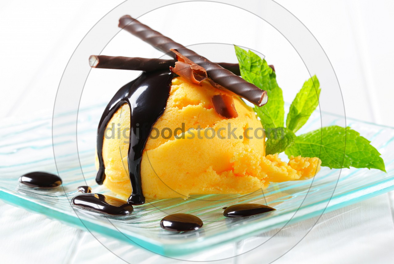Ice cream with chocolate sauce and mint sticks